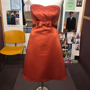 Burnt orange strapless dress with bow detail